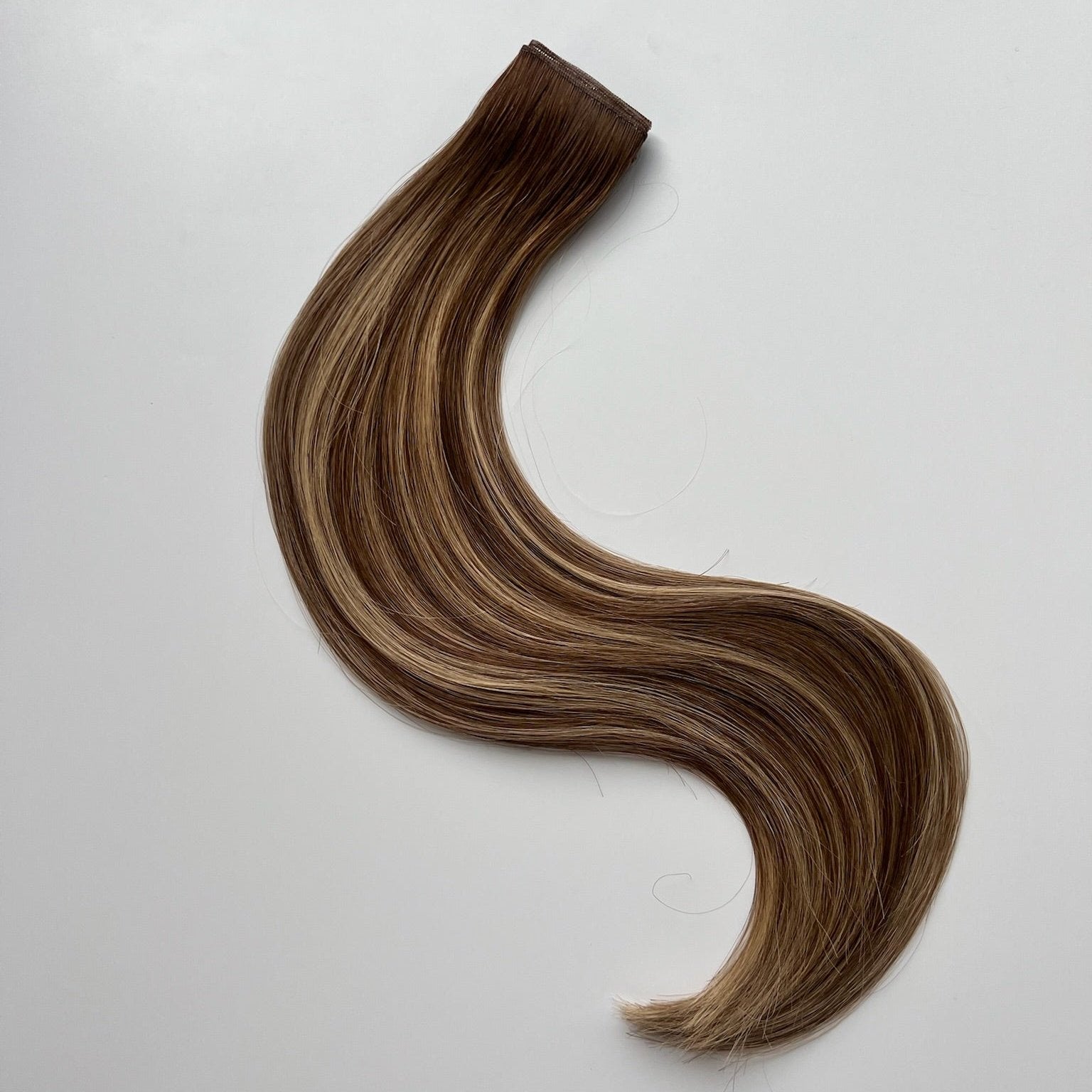 Jenny color Siren Hair Extensions featuring a warm Level 7 base with piano-keyed dimensional ends, including warm Level 7 lowlights and Level 10 warmer blonde highlights. Ideal for natural blondes seeking a lived-in, dimensional look.
