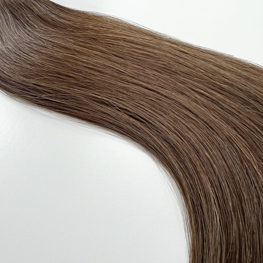 Anna color Siren Hair Extensions featuring a neutral Level 6 brunette shade, showcasing premium Remy Human Hair with a natural, root-to-end even tone. Ideal for creating darker brunette styles.