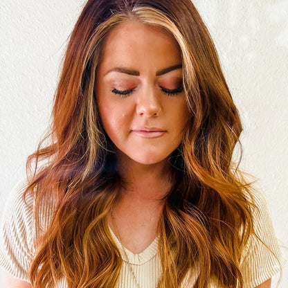 Hannah color Siren Hair Extensions featuring a warm Level 7 base with Level 9 warm copper blonde ends, offering a solid color with no dimension. Ideal for creating vibrant copper redhead styles.