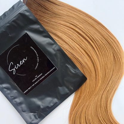 Hannah color Siren Hair Extensions featuring a warm Level 7 base with Level 9 warm copper blonde ends, offering a solid color with no dimension. Ideal for creating vibrant copper redhead styles.