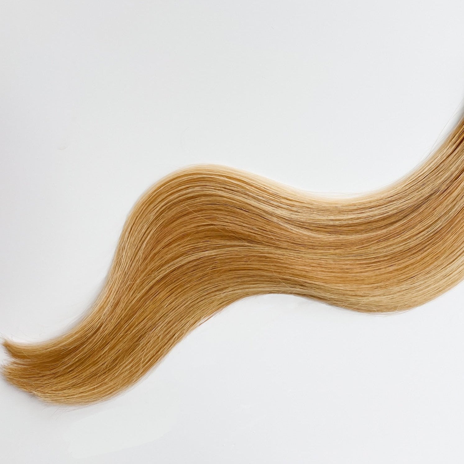 Heidi color Siren Hair Extensions featuring a golden copper Level 8 base with piano-keyed dimensional ends, including Level 9 golden copper lowlights and Level 10 sunny golden blonde highlights. Perfect for natural strawberry blonde and sunny blonde styles.