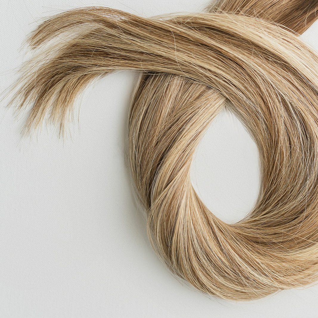 Jenny color Siren Hair Extensions featuring a warm Level 7 base with piano-keyed dimensional ends, including warm Level 7 lowlights and Level 10 warmer blonde highlights. Ideal for natural blondes seeking a lived-in, dimensional look.