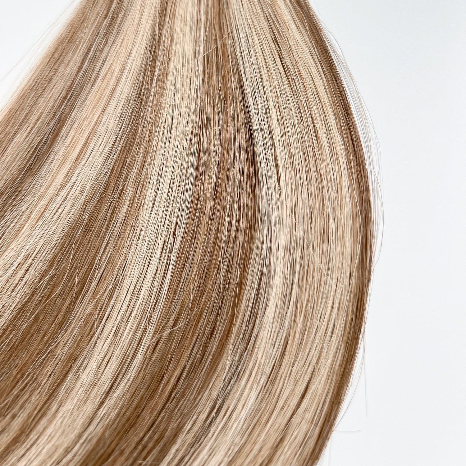 Jenny color Siren Hair Extensions featuring a warm Level 7 base with piano-keyed dimensional ends, including warm Level 7 lowlights and Level 10 warmer blonde highlights. Ideal for natural blondes seeking a lived-in, dimensional look.