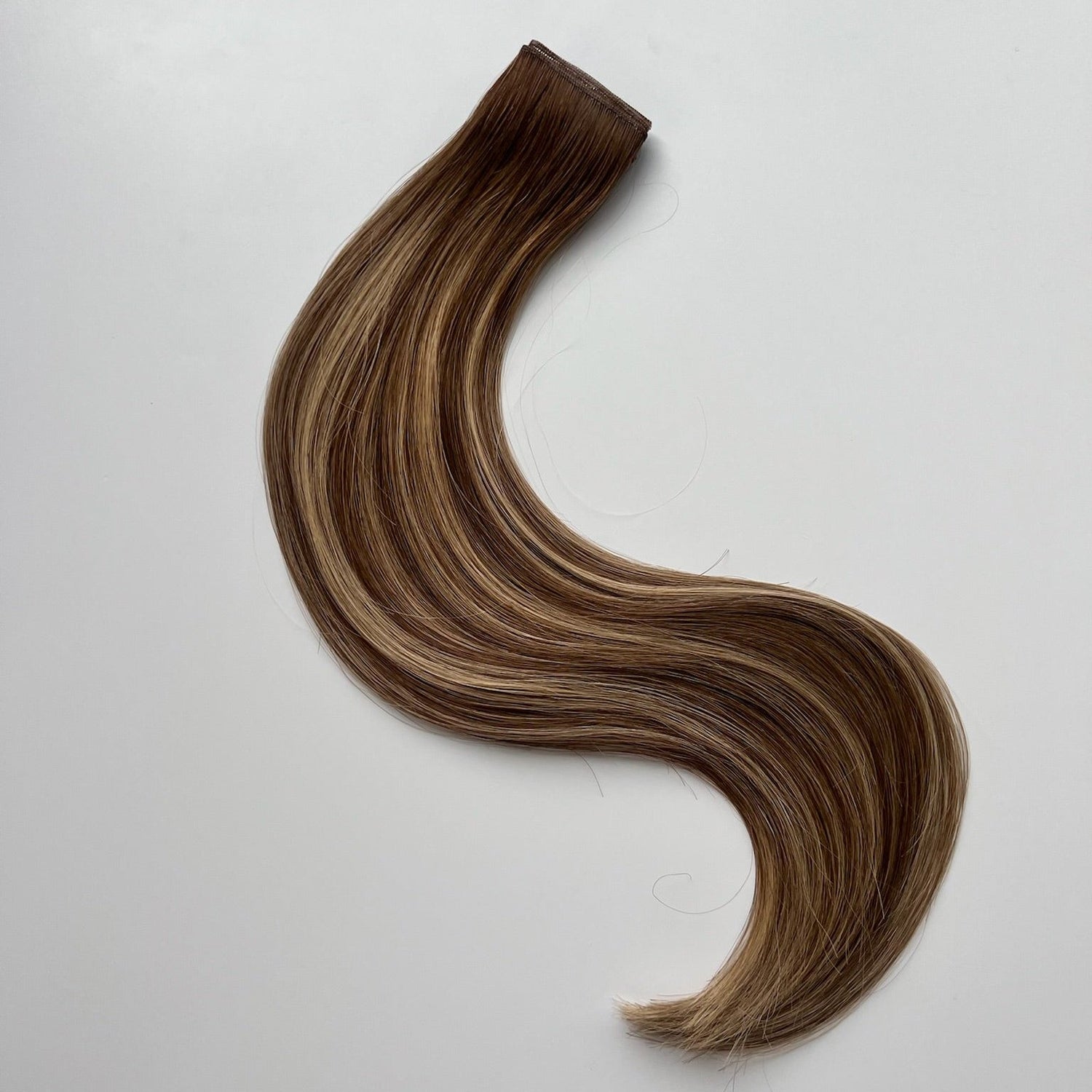 Jenny color Siren Hair Extensions featuring a warm Level 7 base with piano-keyed dimensional ends, including warm Level 7 lowlights and Level 10 warmer blonde highlights. Ideal for natural blondes seeking a lived-in, dimensional look.