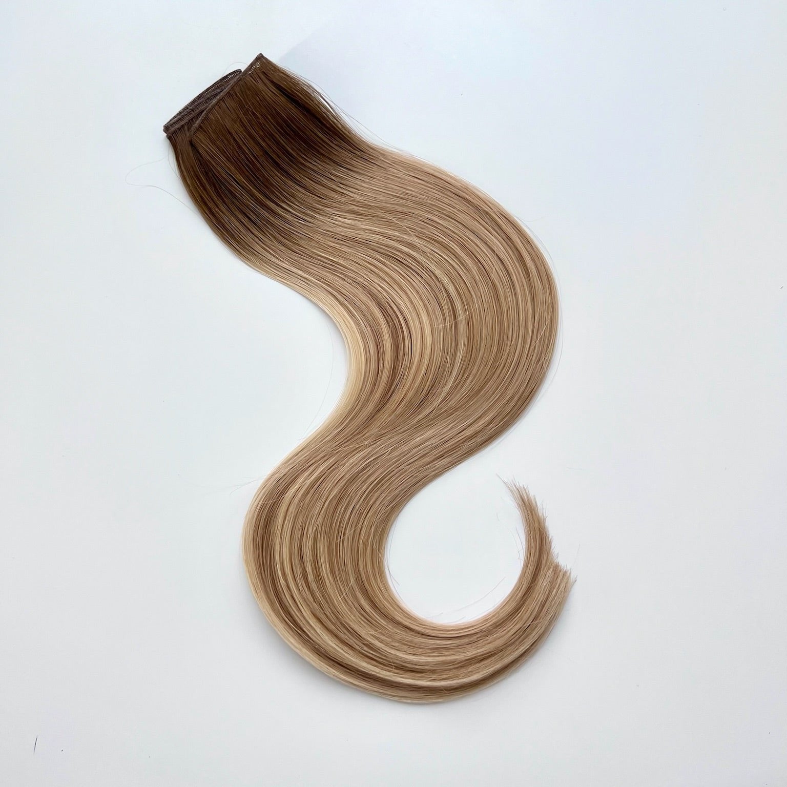 Kayla color Siren Hair Extensions featuring a warm Level 7 base with piano-keyed dimensional ends, including Level 9 sunny golden blonde lowlights and Level 10 sunny golden blonde highlights. Perfect for creating a lived-in sunny blonde look.