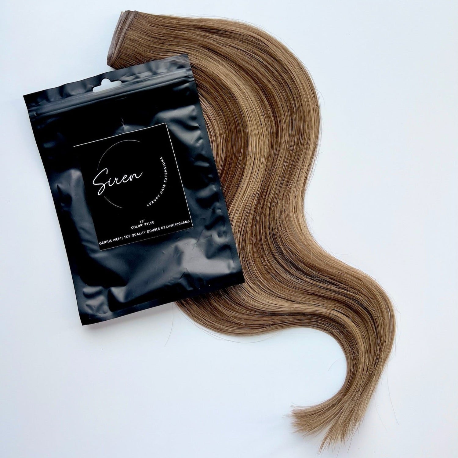 Kylee color Siren Hair Extensions featuring a neutral Level 7 base with piano-keyed dimensional ends, including neutral Level 7 lowlights and champagne blonde Level 9 highlights. Ideal for natural brunettes seeking a subtle bronde effect.