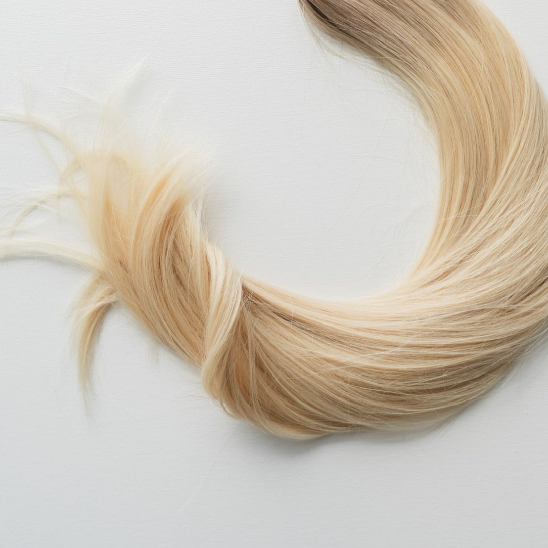 Misty color Siren Hair Extensions featuring a neutral/cool Level 9 base with solid neutral Level 10 ends, offering a sleek, dimension-free look. Ideal for achieving platinum blonde or Barbie-hair perfection.