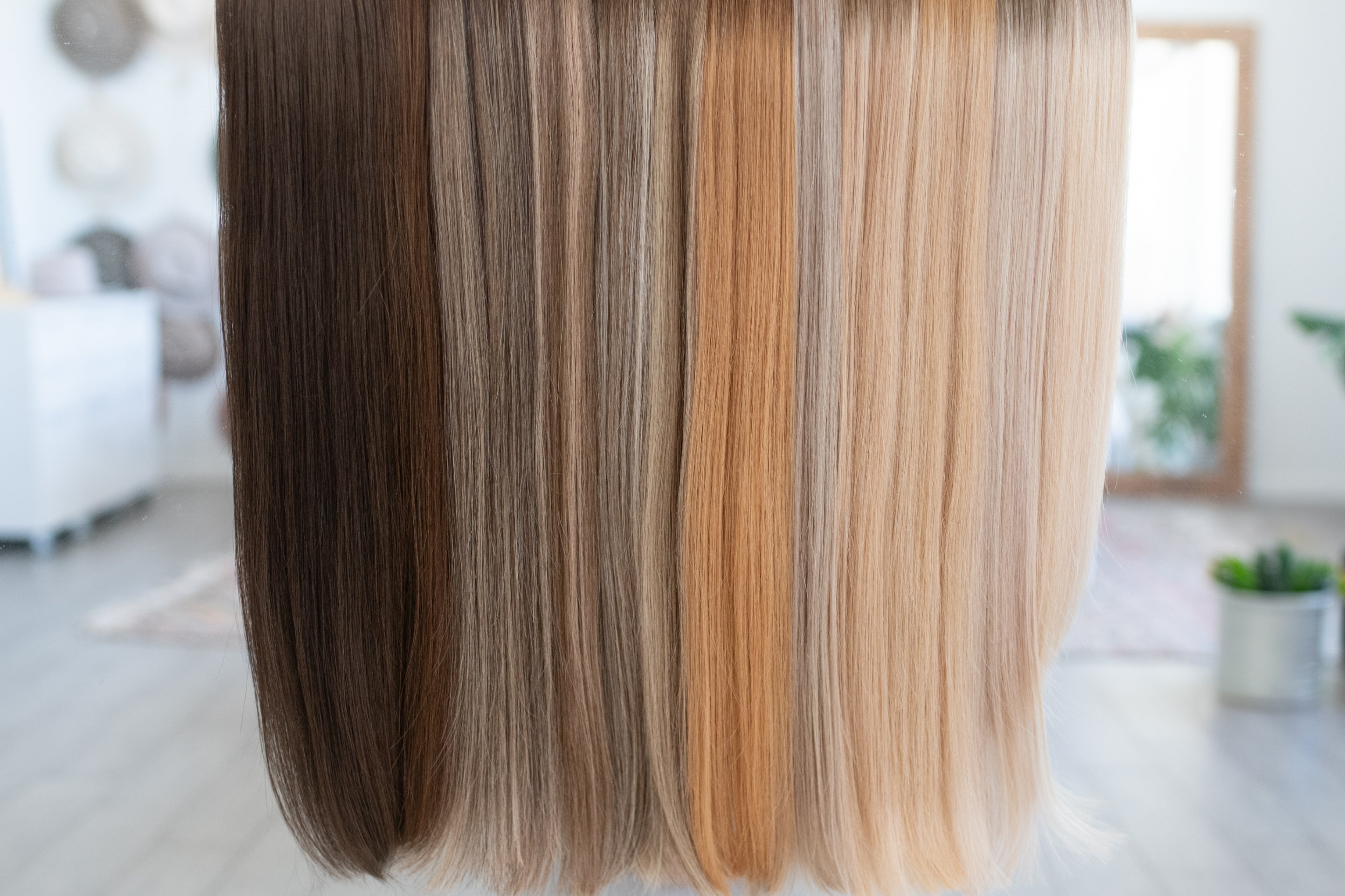 Assorted shades of Siren Luxury Hair Extensions, featuring a range of colors from rich brunettes to golden blondes, displayed to showcase the natural texture, shine, and premium quality of the extensions.