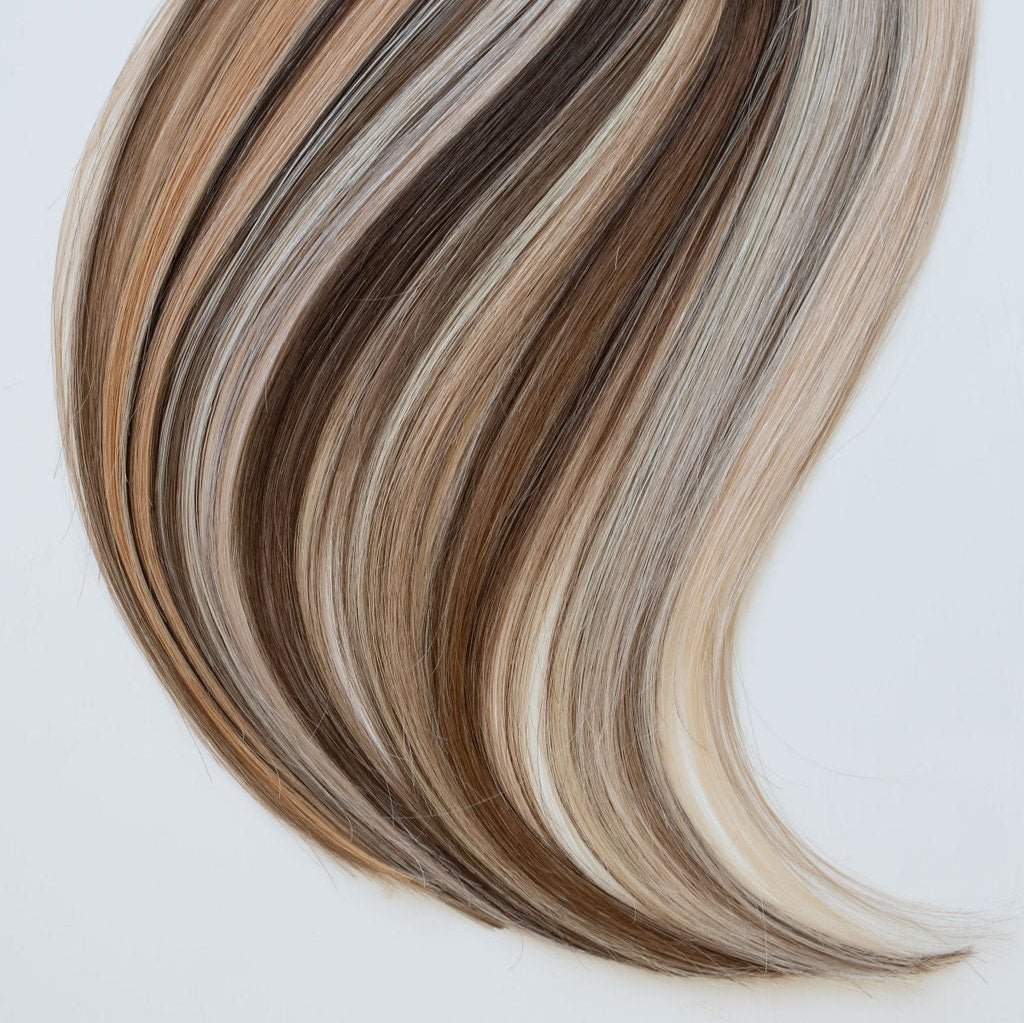 Siren Hair Extensions swatch ring showcasing a variety of premium genius weft extension shades, including an array of blondes, brunettes, and dimensional tones. Ideal for professional stylists to accurately match and select hair extension colors.